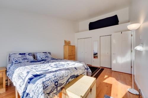 a bedroom with a bed with a blue and white comforter at Mountain Views for Miles! Apt Near Homer Spit in Homer