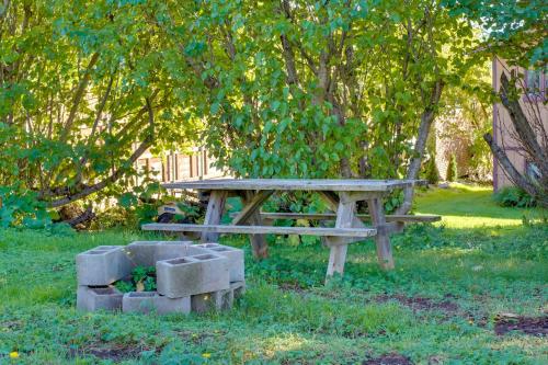a picnic table in the grass under a tree at Mountain Views for Miles! Apt Near Homer Spit in Homer