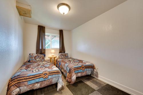 a bedroom with two beds and a window at Fish and Hike! Home Base for Kachemak Bay Adventures in Homer