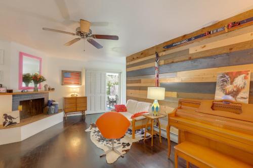 a living room with a piano and a couch at 12 Mi to Denver Home with Game Room in Wheat Ridge in Wheat Ridge