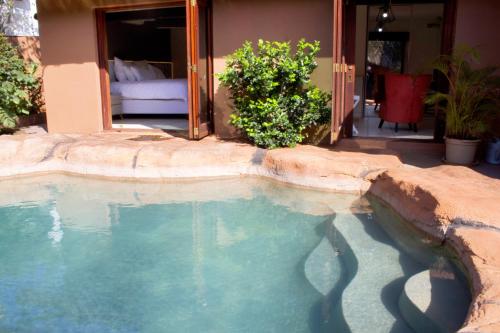 a large pool of water in front of a house at Elroiairbnb in Amanzimtoti