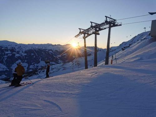 a group of people on a ski lift on a snow covered slope at Ferienwohnung Garber in Zell am Ziller