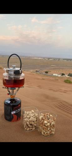 a food machine with two containers of nuts in the desert at Aman dome desert in Ḩawīyah