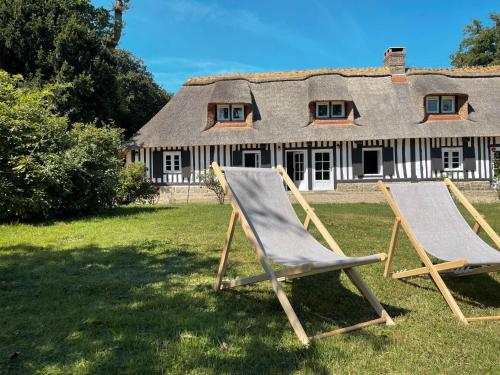two lawn chairs in front of a house at Clos de Leger in Pleine-sève