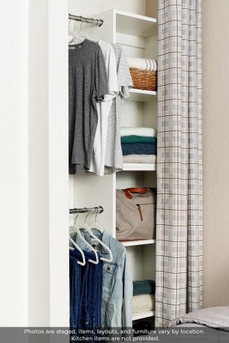 a closet filled with lots of clothes at InTown Suites Extended Stay Houston TX Webster - NASA in Webster