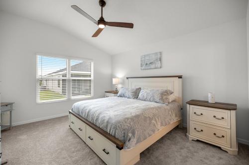 a bedroom with a bed and a ceiling fan at Spacious 2BR in The Villages With Golf Cart and King Bed in Sumterville