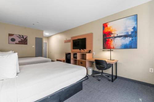 a hotel room with a bed and a desk at Americas Best Value Inn & Suites-Livingston in Livingston