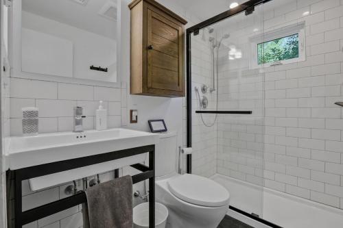 a bathroom with a toilet and a sink and a shower at House Under The Cliff in New Paltz