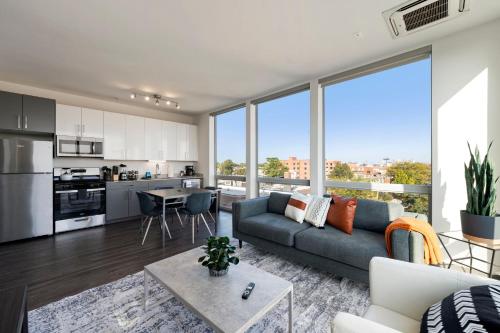a living room with a couch and a table at 2BR City Loft Amazing Glass Views in Chicago