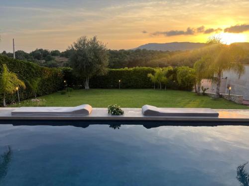a swimming pool with two pillows on top of it at Villa Lucia With Salt Pool in Fontane Bianche