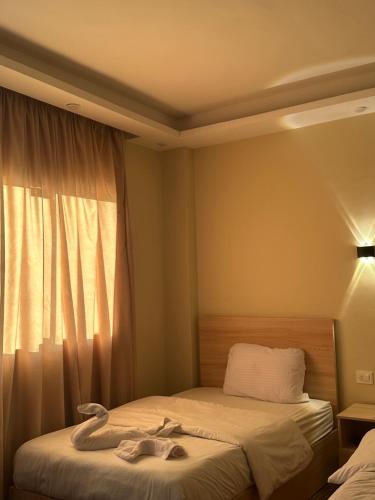 a hotel room with two beds and a window at Thoth pyramids view hotel in Cairo