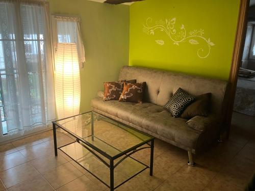 a living room with a couch and a glass table at Hostal Ekaitza in Lesaka