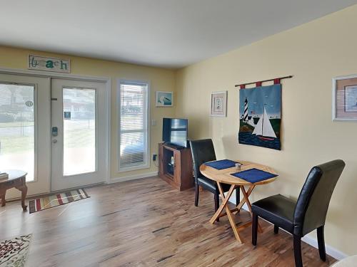 a living room with a dining room table and chairs at Grand Caribbean Perdido Key #101 West in Perdido Key