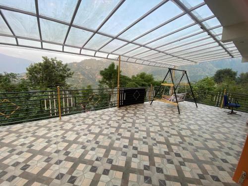 a balcony with a swing and a swing at Gautam Ashiyana Home stay in KumhÄrsain