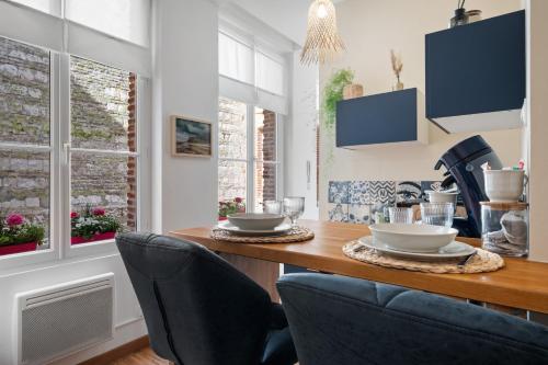 a dining room with a table and two chairs at Studio Saint Rémy Dieppe in Dieppe