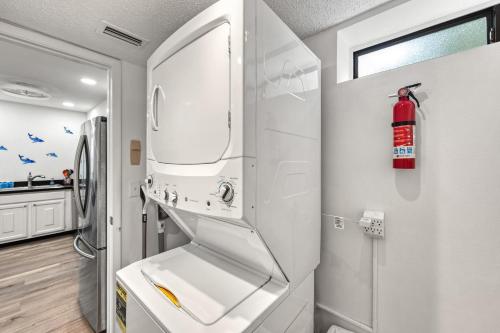 a kitchen with a sink and a refrigerator at Coastal Condo, Water Views, Fishing Dock & 0.6 Miles to Siesta Beach in Siesta Key