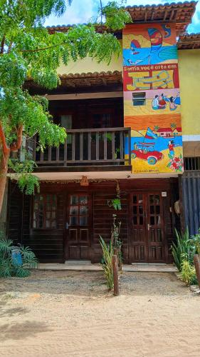 a house with a painting on the side of it at MarJeri in Jericoacoara