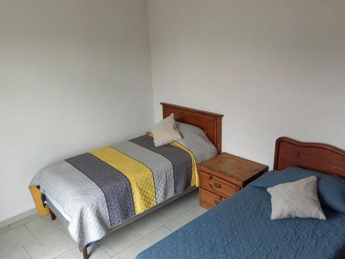 a bedroom with two beds and a night stand at Entire apartment on Av Tollocan in Toluca