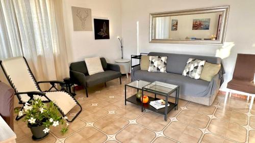a living room with a couch and chairs at Villa Lucia With Salt Pool in Fontane Bianche
