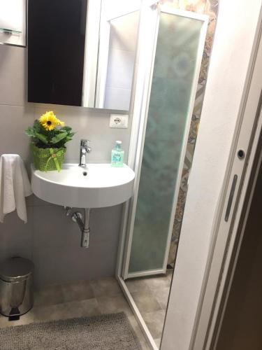 a bathroom with a sink and a shower with a mirror at Villa Lucia With Salt Pool in Fontane Bianche