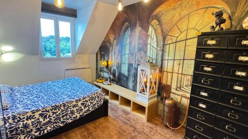 a bedroom with a bed and a dresser at Chez les Stephs in Magny-le-Hongre