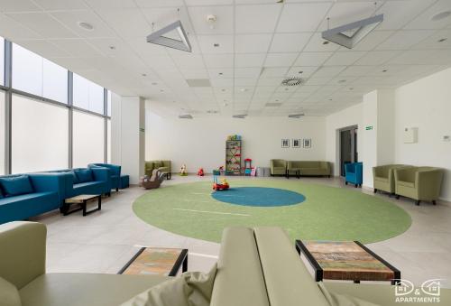 an empty waiting room with chairs and a playground at Mewa Aquamarina Onyx D&D Apartments in Międzyzdroje