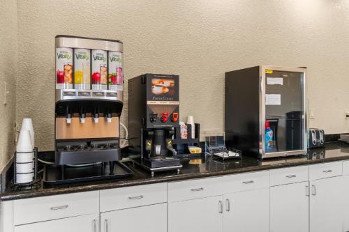 a counter with a coffee station with a coffee maker at Americas Best Value Inn & Suites-Livingston in Livingston