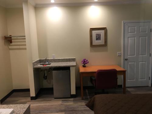 a bathroom with a sink and a table and a table at Lincoln Park Motel in Los Angeles