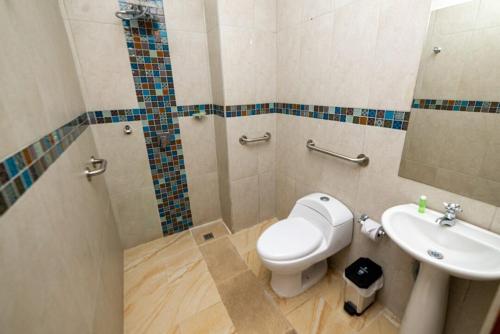 a bathroom with a toilet and a sink at Hotel Santa Laura in Jericó