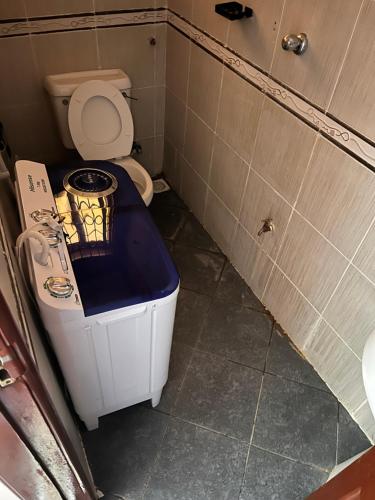 a small bathroom with a toilet in a stall at Sunset Hideaway in Kilifi