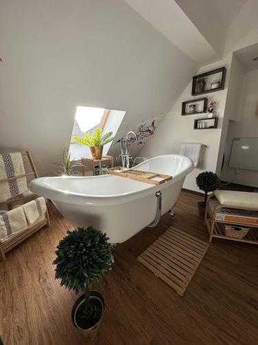 a large white bath tub in a room at Statek Březina in Březina