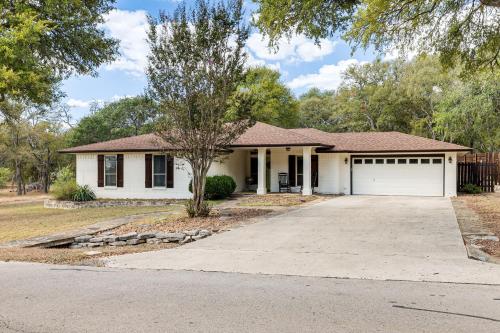 a white house with a garage at Gorgeous San Marco Home with Patio and Grill! in San Marcos