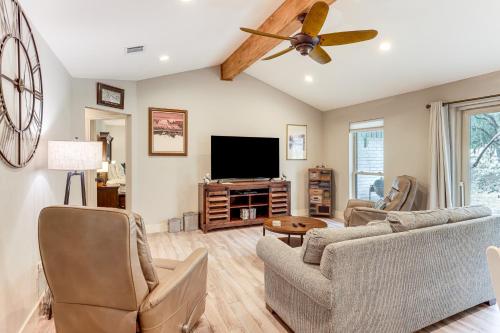 a living room with a couch and a flat screen tv at Gorgeous San Marco Home with Patio and Grill! in San Marcos