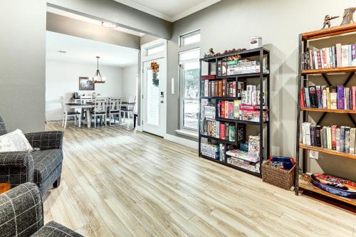 a living room with bookshelves filled with books at Gorgeous San Marco Home with Patio and Grill! in San Marcos
