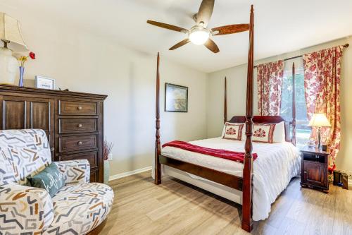 a bedroom with a four poster bed and a chair at Gorgeous San Marco Home with Patio and Grill! in San Marcos