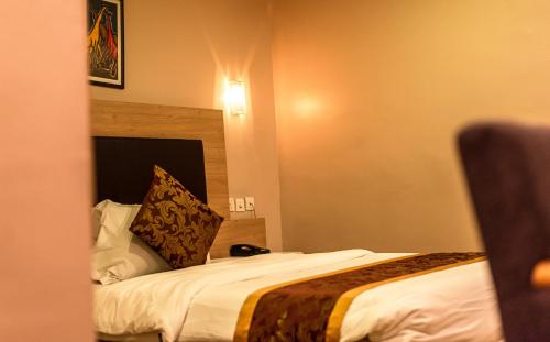 a hotel room with a bed in a room at Visa Karena Hotels in Port Harcourt