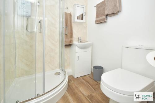 a bathroom with a shower and a toilet and a sink at 2 Bedroom Central Stay in Stoke on Trent