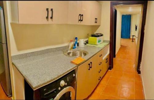 a kitchen with a sink and a counter top at اهرامات بورتو السخنة in Ain Sokhna