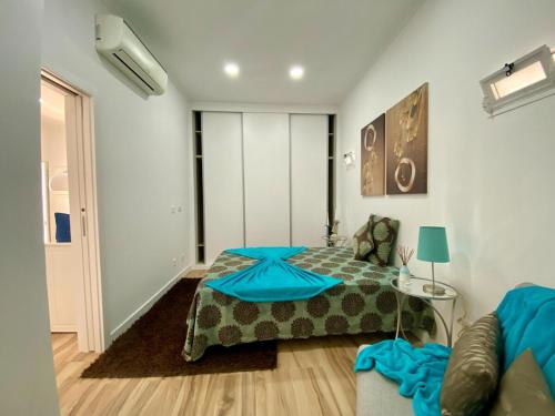 a bedroom with a bed and a couch at Light Keys-Setubal DownTown&Beach in Setúbal