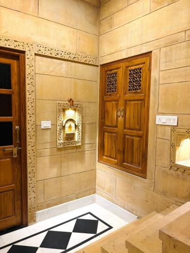an empty room with a door and a mirror at Hotel Muskan Heritage in Jaisalmer