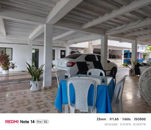 a car parked under a pavilion with a table and chairs at Hotel donde Tito in Tolú