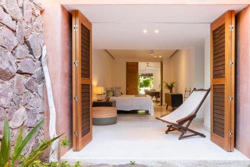 a room with a view of a bedroom and a living room at El Careyes Club & Residences in Careyes