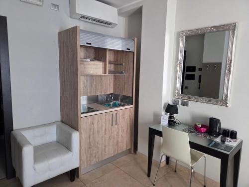 a room with a desk and a sink and a mirror at Residence Hotel Le Viole in Rimini