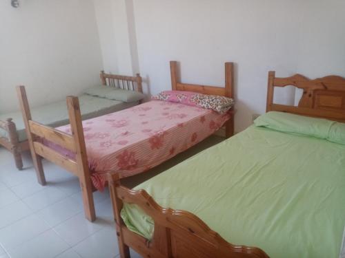 a room with three beds in a room at Buer Youth Hostel in Marsa Matruh