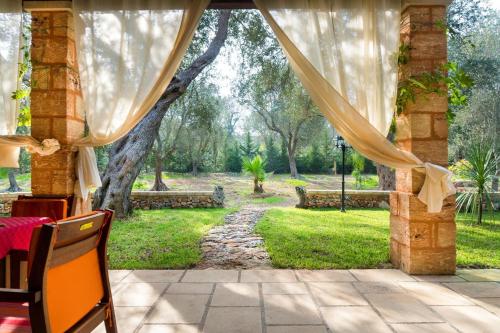 a view of a garden from a patio at Villa Astrea in Andrano