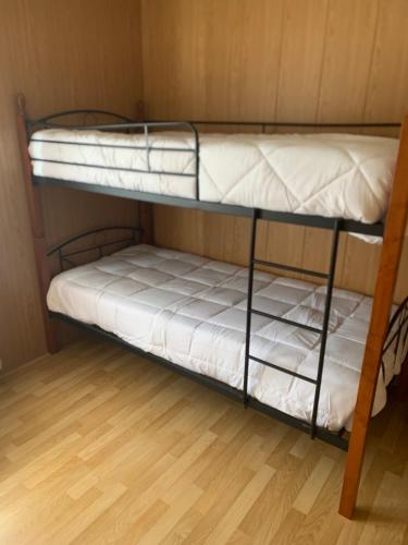 two bunk beds in a room with a wooden floor at Pomares Country House in Melgaço