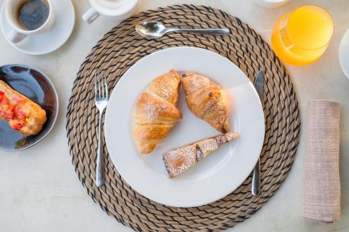 two pastries on a white plate on a table at Terra Dei Limoni in Noto Marina