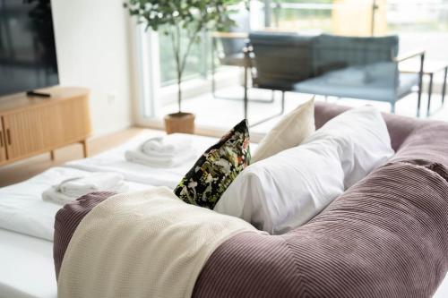 a living room with a couch with pillows at SimpleSparks I Luzern I Andermatt I Natur I Family in Altdorf