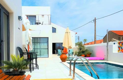 a patio with a pool and a table and chairs at Casa do Campinho B&B boutique guest house in Reguengos de Monsaraz