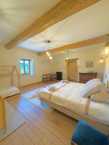 a bedroom with a large bed in a room at Le Domaine de la Source in Chauffailles